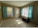 Sun-filled living room featuring tiled floors, lots of windows, and neutral-colored walls at 1008 Se 26Th St, Ocala, FL 34471