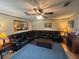 Cozy living room with a large sectional sofa, a wood-burning fireplace, and soft carpeting at 1008 Se 26Th St, Ocala, FL 34471