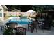 Inviting backyard pool with lounge chairs, umbrellas, and a gazebo, perfect for outdoor relaxation at 1008 Se 26Th St, Ocala, FL 34471