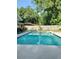 Refreshing in-ground pool is surrounded by a spacious patio, privacy fence, and backyard at 1008 Se 26Th St, Ocala, FL 34471