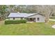 Aerial view of the home with a metal roof, patio, and a large grassy yard at 1010 Sw 26Th St, Ocala, FL 34471