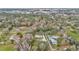 An aerial shot showcases the house's location amid lush greenery and mature trees in a neighborhood setting at 1010 Sw 26Th St, Ocala, FL 34471