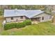 Aerial view of home's backyard with a covered patio area featuring an outdoor dining set and barbecue grill at 1010 Sw 26Th St, Ocala, FL 34471