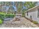 View of the backyard patio including metal furniture, a fire pit, and landscaping at 1010 Sw 26Th St, Ocala, FL 34471