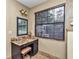 Bathroom vanity and makeup area featuring dark wood cabinets, granite countertops, and natural lighting at 1010 Sw 26Th St, Ocala, FL 34471