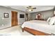 Large carpeted bedroom showcasing a decorative ceiling fan, closet and TV at 1010 Sw 26Th St, Ocala, FL 34471