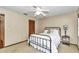 Cozy bedroom with a ceiling fan, black metal bed frame, and a view to an adjacent room at 1010 Sw 26Th St, Ocala, FL 34471