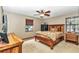 Bedroom featuring a wooden bed frame, ceiling fan, and natural light from the windows at 1010 Sw 26Th St, Ocala, FL 34471