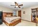 Bedroom with wooden bed frame, ceiling fan, window and view to the entrance of the room at 1010 Sw 26Th St, Ocala, FL 34471