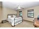 Comfortable bedroom featuring a black metal bed frame, ceiling fan, and natural light from the windows at 1010 Sw 26Th St, Ocala, FL 34471