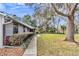 Exterior view of the property showing well-maintained landscaping, including a lawn, bushes and trees at 1010 Sw 26Th St, Ocala, FL 34471