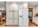 Kitchen area featuring white cabinetry, a modern refrigerator, and hardwood floors at 1010 Sw 26Th St, Ocala, FL 34471