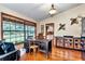 Home office with hardwood flooring, a large window, built-in shelving, and a comfortable seating area at 1010 Sw 26Th St, Ocala, FL 34471