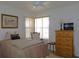 Bedroom featuring a queen bed, dresser, side table, and a bright window at 13100 Se 93Rd Terrace Rd, Summerfield, FL 34491