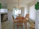 Well-lit dining area adjacent to the living room, complete with a wooden table and a decorative chandelier at 13100 Se 93Rd Terrace Rd, Summerfield, FL 34491