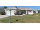 Inviting home with a garage, a lamp post, well-maintained lawn, landscaping and a cozy front porch at 13100 Se 93Rd Terrace Rd, Summerfield, FL 34491