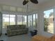 Bright sunroom featuring large windows offering serene backyard views, perfect for relaxation and entertaining at 13100 Se 93Rd Terrace Rd, Summerfield, FL 34491