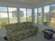 Bright sunroom with views of the fenced backyard and neighborhood, perfect for enjoying the outdoors indoors at 13100 Se 93Rd Terrace Rd, Summerfield, FL 34491