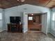 Relaxing room with tile flooring, french doors to living room, large television, and wood plank ceiling at 1546 Sw 153Rd Sw Ct, Ocala, FL 34481