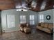 Bright sunroom featuring wood ceilings, tile floors, neutral furniture, and shuttered windows at 1546 Sw 153Rd Sw Ct, Ocala, FL 34481