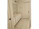 A clean bathroom with double sinks and a large mirror offers ample space at 162 Riggings Way, Clermont, FL 34711