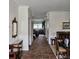 Hallway view leading to a kitchen and dining area with tiled floors and elegant decor at 162 Riggings Way, Clermont, FL 34711