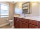 Bathroom vanity with a framed mirror, vanity lights, sink, and marble countertops at 16276 Sw 14Th Ct, Ocala, FL 34473