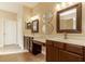 Bathroom featuring double sinks, vanity area, framed mirrors and tiled floor at 16276 Sw 14Th Ct, Ocala, FL 34473