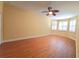Bright bedroom featuring hardwood floors, a ceiling fan, and white shuttered windows that let in plenty of natural light at 16276 Sw 14Th Ct, Ocala, FL 34473