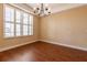 Dining room with wood floors, neutral walls, plantation shutters, and chandelier, ideal for hosting gatherings at 16276 Sw 14Th Ct, Ocala, FL 34473