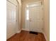 Entryway featuring wood floors, a sidelight door, and a storage closet, offering a welcoming entrance at 16276 Sw 14Th Ct, Ocala, FL 34473