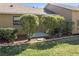 Exterior view of the home showing well-manicured hedges near the house and a side entrance at 16276 Sw 14Th Ct, Ocala, FL 34473