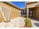 Inviting front entrance with a tiled porch, stylish trellis, and well-maintained landscaping at 16276 Sw 14Th Ct, Ocala, FL 34473