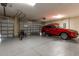 View of a clean and spacious garage, with a car parked inside, featuring two garage doors at 16276 Sw 14Th Ct, Ocala, FL 34473