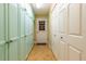 Hallway with built-in storage cabinets, tile flooring, and access to the exterior of the house at 16276 Sw 14Th Ct, Ocala, FL 34473