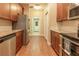 A functional kitchen featuring stainless steel appliances and wood cabinets with granite countertops at 16276 Sw 14Th Ct, Ocala, FL 34473