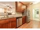 Kitchen featuring wood cabinets, granite countertops and stainless steel appliances at 16276 Sw 14Th Ct, Ocala, FL 34473