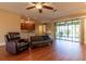 Inviting living room with wood floors and seamless flow to the kitchen and outdoor space, perfect for entertaining at 16276 Sw 14Th Ct, Ocala, FL 34473