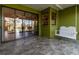 Covered patio featuring tile flooring, with a swing and sliding glass doors leading to the home's interior at 16276 Sw 14Th Ct, Ocala, FL 34473