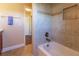 Shower-tub featuring tiled walls, a built-in niche, and a window to brighten the space at 16276 Sw 14Th Ct, Ocala, FL 34473