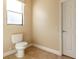 Bright bathroom features a standard toilet, neutral paint, and a window for natural light at 16276 Sw 14Th Ct, Ocala, FL 34473