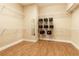 Spacious walk-in closet with wood flooring and shelving for organization and storage at 16276 Sw 14Th Ct, Ocala, FL 34473