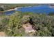 Lakefront property surrounded by trees visible in this areal view at 17153 Se 79Th Street Rd, Ocklawaha, FL 32179