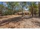 Backyard and exterior view of this lakefront home surrounded by trees at 17153 Se 79Th Street Rd, Ocklawaha, FL 32179