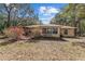 Rear exterior view of a well-maintained home with a large, tree-filled backyard at 17153 Se 79Th Street Rd, Ocklawaha, FL 32179