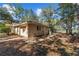 View of home's exterior featuring a two car garage and plentiful tree coverage at 17153 Se 79Th Street Rd, Ocklawaha, FL 32179