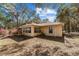 Exterior side angle of a home with plentiful tree coverage and a sunroom at 17153 Se 79Th Street Rd, Ocklawaha, FL 32179