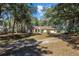 Charming single-story home with a well-maintained front lawn and mature trees offering shade at 17153 Se 79Th Street Rd, Ocklawaha, FL 32179