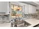 Kitchen sink featuring stainless fixtures, white countertops, and a window with a waterfront view at 17153 Se 79Th Street Rd, Ocklawaha, FL 32179