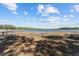 Picturesque view of lake with a dock surrounded by grass and shadows at 17153 Se 79Th Street Rd, Ocklawaha, FL 32179